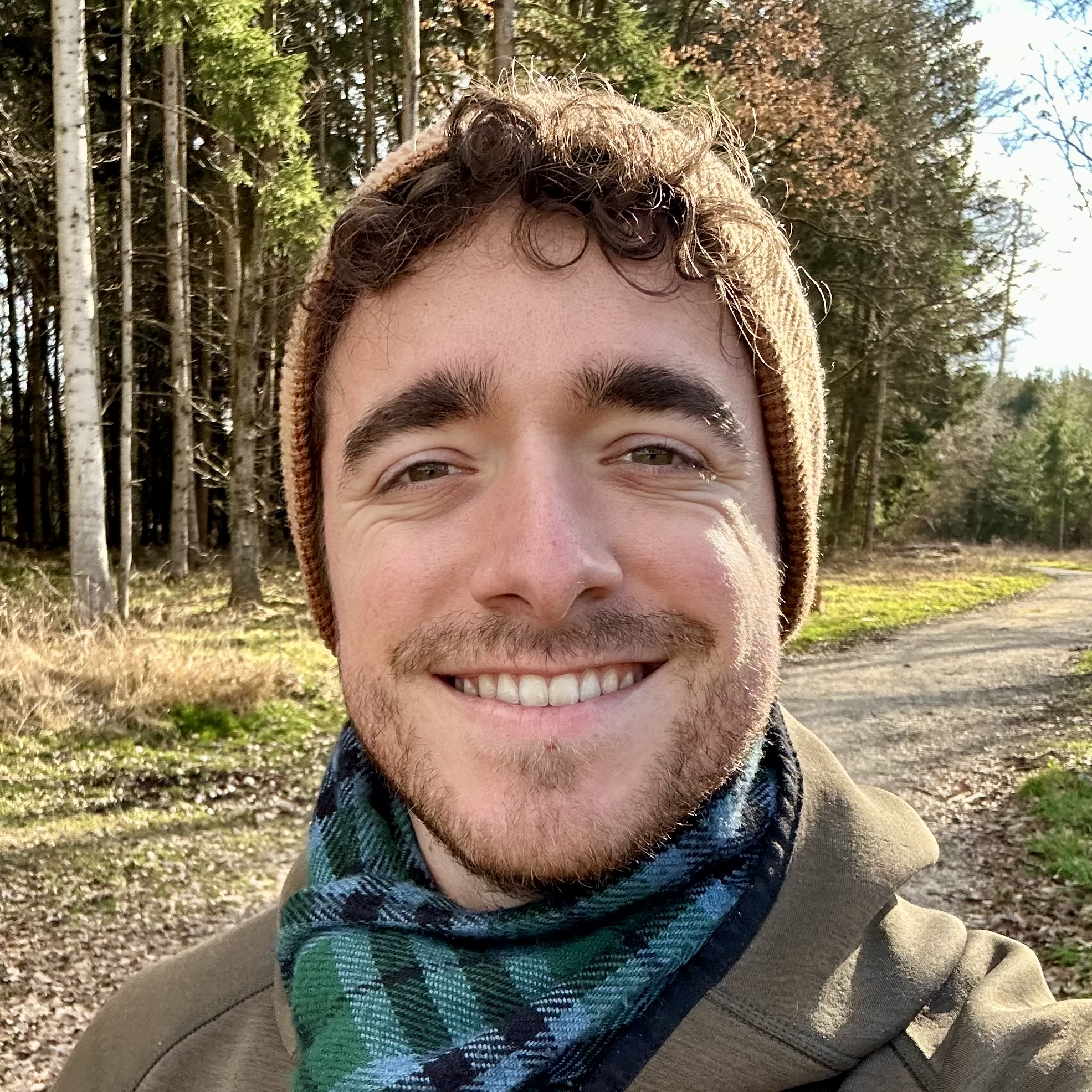 Samuel, content creator and marketer, standing in a forest
